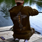 Fisherman wearing Vass Carp Rising Hoodie Cap Easy Bac Fishing Trainers and Culture Joggers