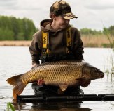 Lady Carp Angler holding fish wearing Vass 700 Chest Waders